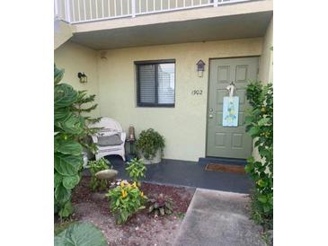 Inviting condo entry with landscaping and a charming front door at 25225 Rampart Blvd # 1902, Punta Gorda, FL 33983