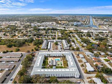 Aerial view of a large apartment complex with pool and courtyard at 4746 Azalea Dr # 105C, New Port Richey, FL 34652