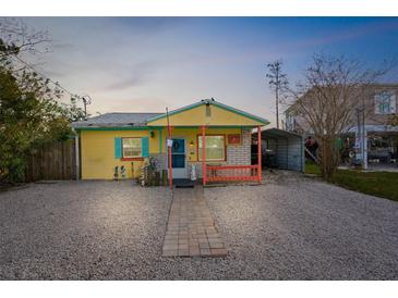 Charming yellow cottage with a walkway, and a carport at 5421 Circle Dr, Weeki Wachee, FL 34607