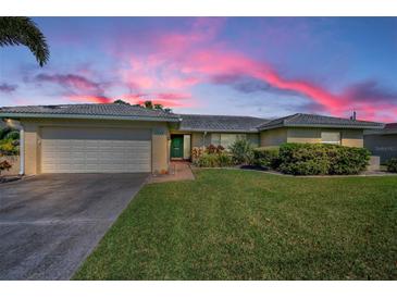 Charming single-story home with well-maintained lawn and attached two-car garage on a picturesque lot at 6909 13Th N Ave, St Petersburg, FL 33710