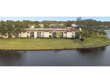 Aerial view of condo building near a lake at 130 Lakeview Way # 130, Oldsmar, FL 34677