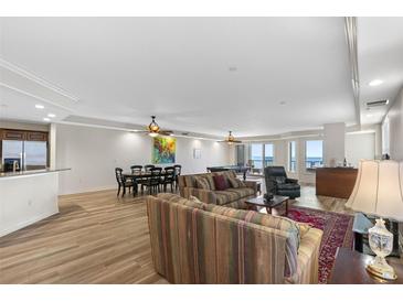 Spacious living room with open floor plan, featuring a pool table and dining area at 19734 Gulf Blvd # 202, Indian Shores, FL 33785