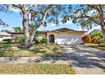 Attractive ranch home with mature trees and a long driveway at 1978 Arvis W Cir, Clearwater, FL 33764