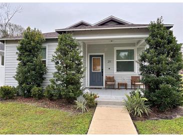 Charming craftsman home with covered porch and well-manicured lawn at 211 W Broad St, Tampa, FL 33604