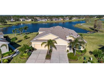 Property features a two-car garage and lakefront view at 2501 Sapphire Greens Ln, Sun City Center, FL 33573