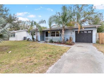 Charming single-story home featuring a well-kept lawn, light blue exterior, and attached garage at 2755 Morningside Dr, Clearwater, FL 33759