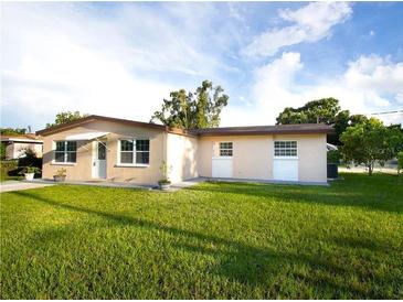 One-story house with a well-maintained lawn and carport at 3916 W Oklahoma Ave, Tampa, FL 33616