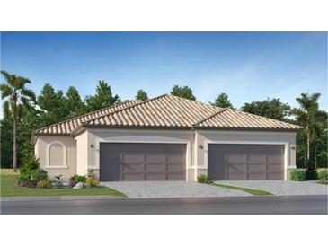 Two-car garage, Spanish-style home with landscaping at 5414 Crystal Harbor Cv, Bradenton, FL 34211