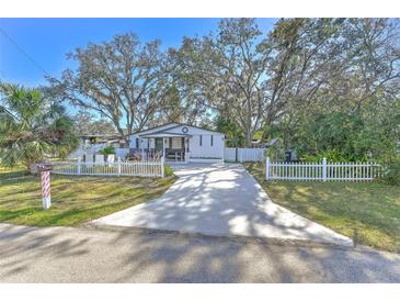 Cute bungalow with white picket fence and spacious driveway at 11121 Roberts Ln, Riverview, FL 33578