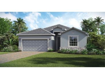 Single-story home with gray siding, stone accents, and a two-car garage at 15053 Sea Salt Way, Bradenton, FL 34211