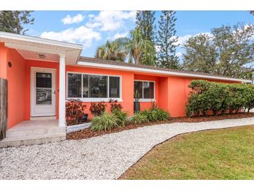 Coral home with landscaped yard and walkway at 1530 Rollen Rd, Clearwater, FL 33755