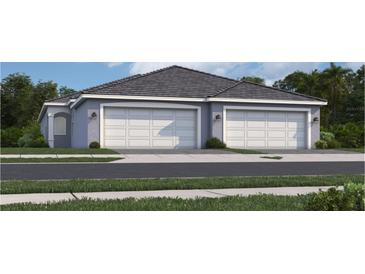 Two-car garage, light gray exterior, landscaping at 15908 Sunny Day Dr, Bradenton, FL 34211