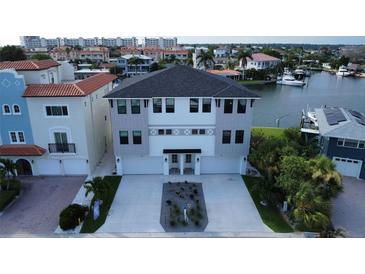 Modern three-story home with waterfront access and two-car garage at 160 174Th Terrace E Dr # B, Redington Shores, FL 33708