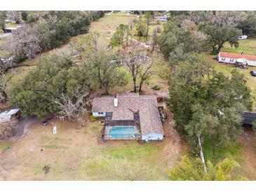 Aerial view showing home, pool, and surrounding property at 3009 Jim Johnson Rd, Plant City, FL 33566