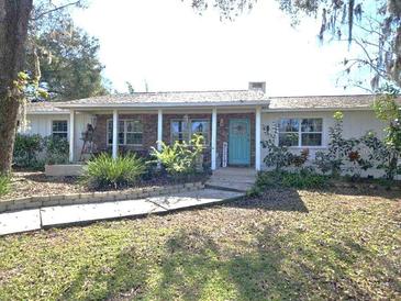 Charming ranch house with a covered porch and landscaped yard at 3009 Jim Johnson Rd, Plant City, FL 33566