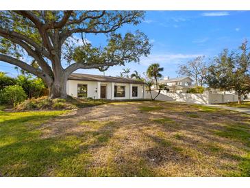 Charming single-story home with a spacious front yard and large oak tree at 431 Rafael Ne Blvd, St Petersburg, FL 33704