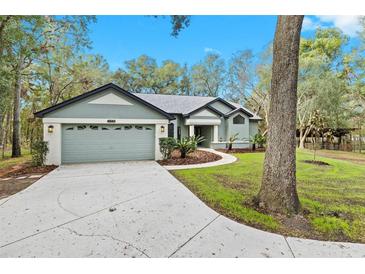 Newly renovated home with a spacious front yard and long driveway at 4540 Oakfield Cir, Dade City, FL 33523