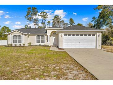 Inviting one-story home with a two-car garage and well-manicured lawn at 6119 Freeport Dr, Spring Hill, FL 34606