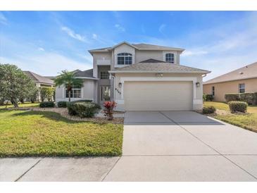 Two-story house with a two-car garage and well-maintained lawn at 8243 47Th Street E Cir, Palmetto, FL 34221