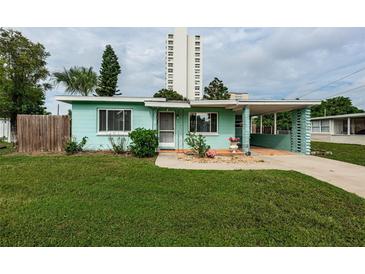 Charming light green house with a well-maintained lawn and driveway at 925 67Th S St, St Petersburg, FL 33707