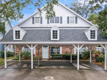 Two-story house with a carport and brick facade at 291 Winchester Way, Palm Harbor, FL 34684