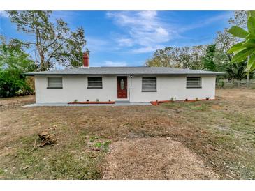 Newly renovated single story home with a modern exterior and landscaped yard at 40242 Sunburst Dr, Dade City, FL 33525