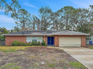 Brick ranch house with attached garage and large yard at 5225 Venetian Ne Blvd, St Petersburg, FL 33703