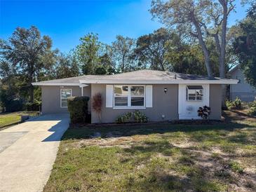 Charming single-story home with a well-maintained lawn and driveway at 1116 E Boyer St, Tarpon Springs, FL 34689