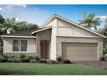 Modern one-story home with stone accents and a two-car garage at 11830 Starbright Path, Venice, FL 34293