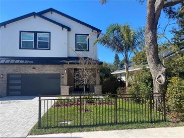 Two-story modern home with brick accents and a gray garage door at 1046 Bass Blvd, Dunedin, FL 34698