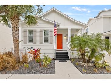 Charming single story home with orange door and landscaped yard at 11220 Moultrie Pl, Tampa, FL 33625