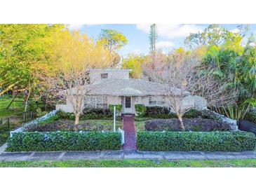 Cute ranch home with brick paver walkway, lush landscaping, and white picket fence at 216 21St Ne Ave, St Petersburg, FL 33704