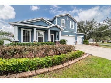 Two-story house with blue siding, white trim, and a landscaped front yard at 2291 Bolzano Ct, Land O Lakes, FL 34639