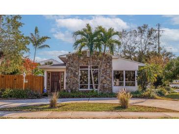 Stone and stucco house with a landscaped yard and driveway at 400 22Nd Ne Ave, St Petersburg, FL 33704