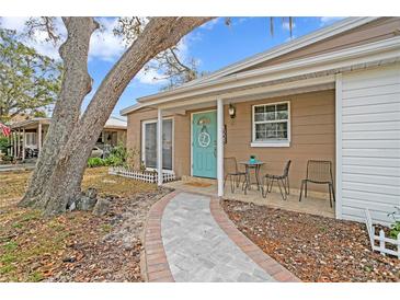 Inviting front exterior with teal door, walkway, and small patio set at 4008 W North B St, Tampa, FL 33609