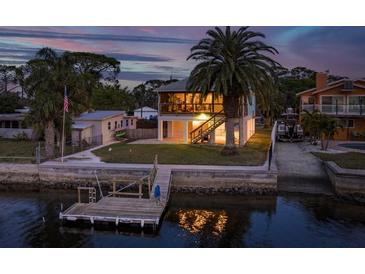 Elevated view of waterfront home with private dock and surrounding landscape at 4536 Heavens Way, New Port Richey, FL 34652