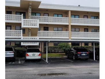 Two-story condo building with covered parking and balconies at 4920 Locust Ne St # 203, St Petersburg, FL 33703