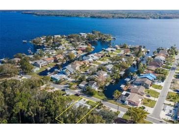 Aerial view of waterfront home with canal access and lush landscaping at 6 Freshwater Dr, Palm Harbor, FL 34684