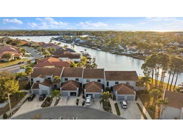 Aerial view of waterfront townhouses with garages and water access at 6320 Grand Bahama Cir # 6320, Tampa, FL 33615