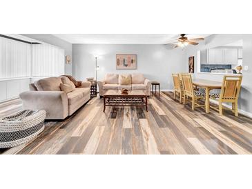 Open living room and kitchen area with wood-look floors and neutral decor at 6960 20Th N Ave # 307, St Petersburg, FL 33710