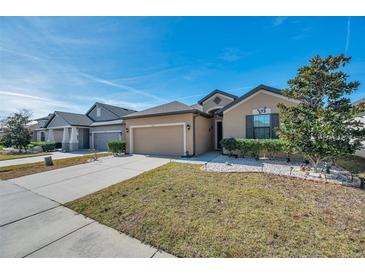 Nice curb appeal! This lovely one-story home features a two-car garage and well-manicured lawn at 954 Old Windsor Way, Spring Hill, FL 34609