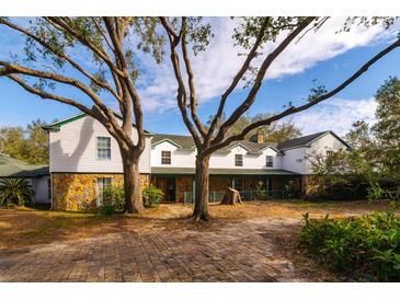 Large two-story home with stone accents and a spacious front yard at 18029 Lake Reflections Blvd, Lutz, FL 33558