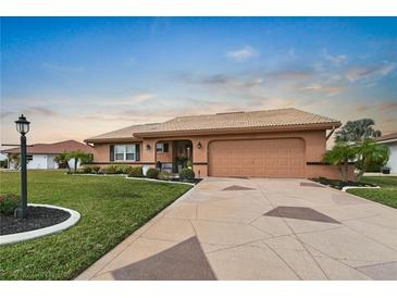 Beautiful single-story home with a large driveway and well-manicured lawn at 1809 Wolf Laurel Dr, Sun City Center, FL 33573