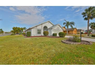 Single-story home with landscaped lawn and driveway at 243 Linger Ln, Sun City Center, FL 33573