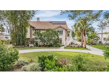 Stunning waterfront home with manicured landscaping and private walkway at 314 Shore E Dr, Oldsmar, FL 34677