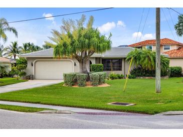 Single-story home with attached garage and lush landscaping at 3560 Tripoli Blvd, Punta Gorda, FL 33950