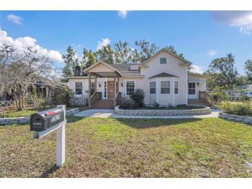 Charming light-yellow house with a well-maintained lawn and stone accents at 37620 Howard Ave, Dade City, FL 33525