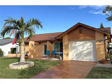 Cute one-story home with palm trees and a well-maintained lawn at 4498 Lake Blvd, Clearwater, FL 33762