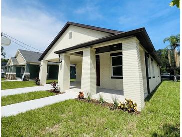 Newly constructed Craftsman style home with front porch and landscaping at 5701 N 20Th St, Tampa, FL 33610