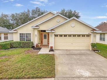 One-story house with a two-car garage and landscaped lawn at 9551 Jaybird Ln, Land O Lakes, FL 34638